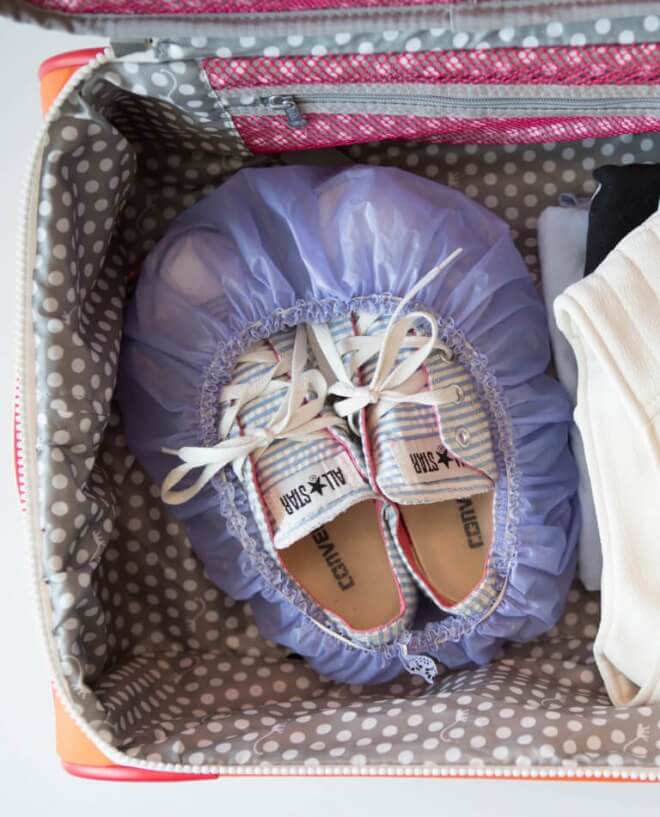 Use a shower cap to keep shoes from dirtying clothes in your suitcase.