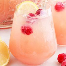 close up shot of glasses of Party Punch with lemon slices and raspberries