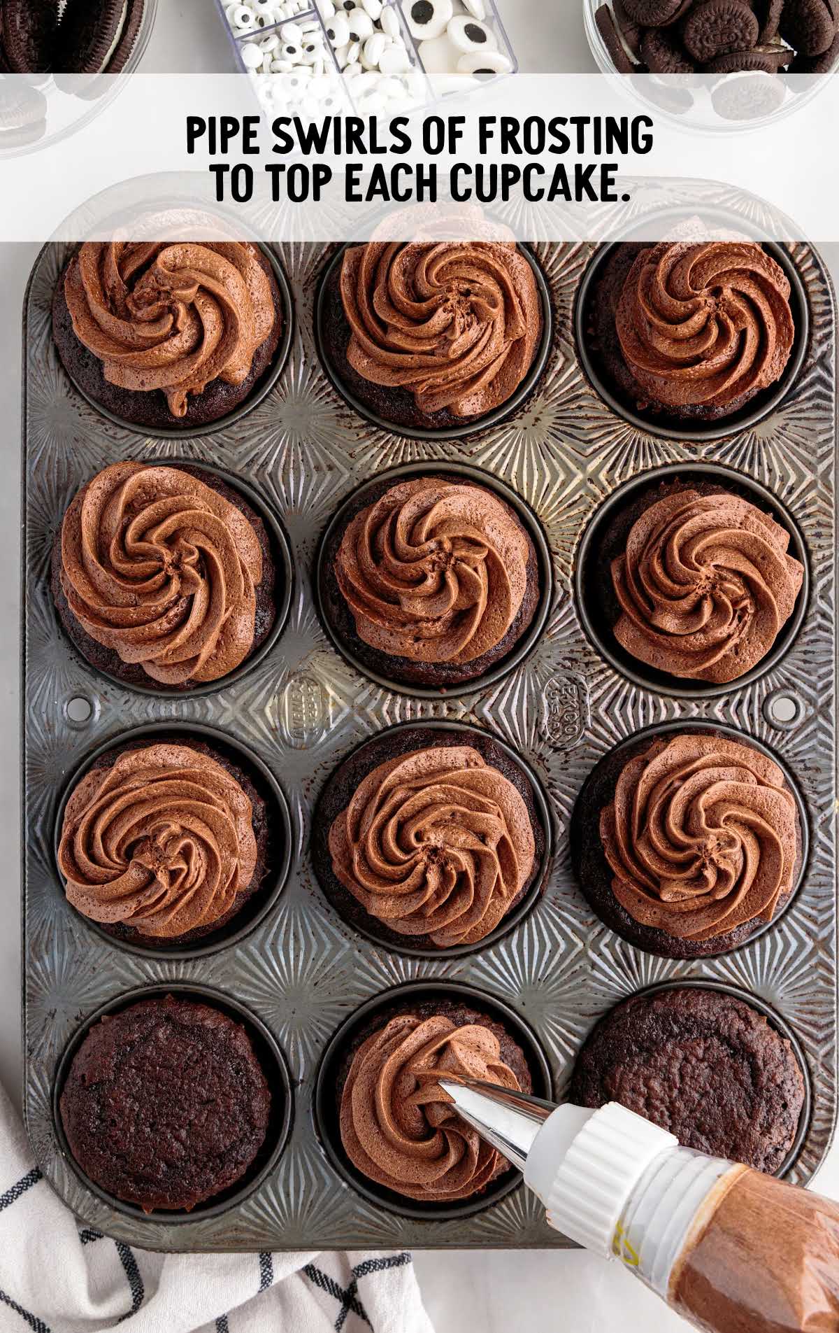 frosting swirled on top of each cupcake in a cupcake pan