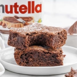 Nutella Brownies stacked on top of each other on a plate