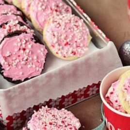 A pink box filled with different types of food, with Christmas cookie