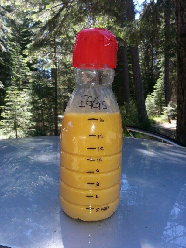 Use a plastic bottle to store, transport and portion scrambled eggs while camping.