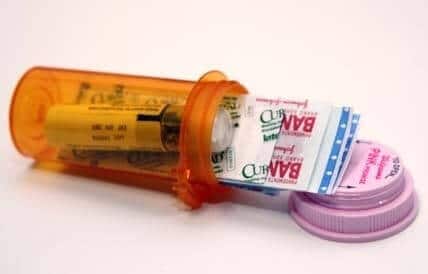 Use a pill bottle to store first aid essentials. 