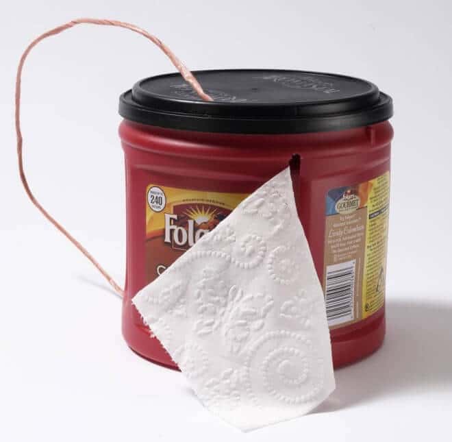 Make a DIY toilet paper holder using an old plastic tub - ideal for camping.