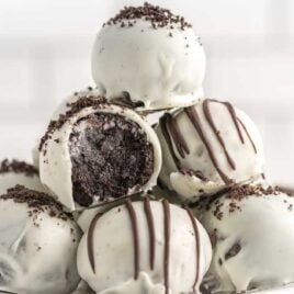 close up shot of Oreo Truffles garnished with oreo crumbles or melted chocolate on a plate