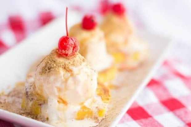 A close up of a piece of cake on a plate, with Pineapple and Cup