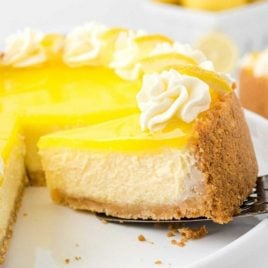lemon cheesecake with a slice being removed with a spatula