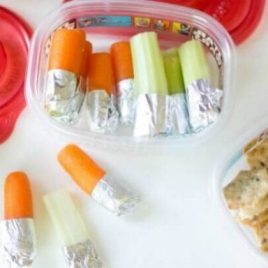 A plastic container filled with different types of food on a tray, with Party