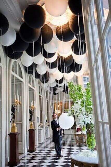 Festive birthday party decor. Minimalistic style. Black and white balloons  hang over number 10 in the restaurant hall Stock Photo