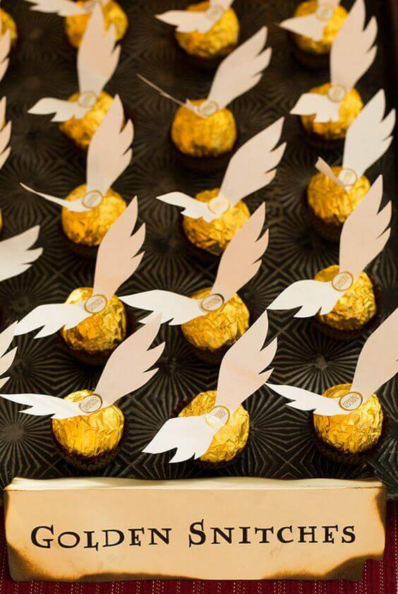 Make simple golden snitches by gluing wings to Ferrero Rocher balls.