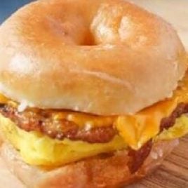 close up shot of a donut sandwich on a wooden board