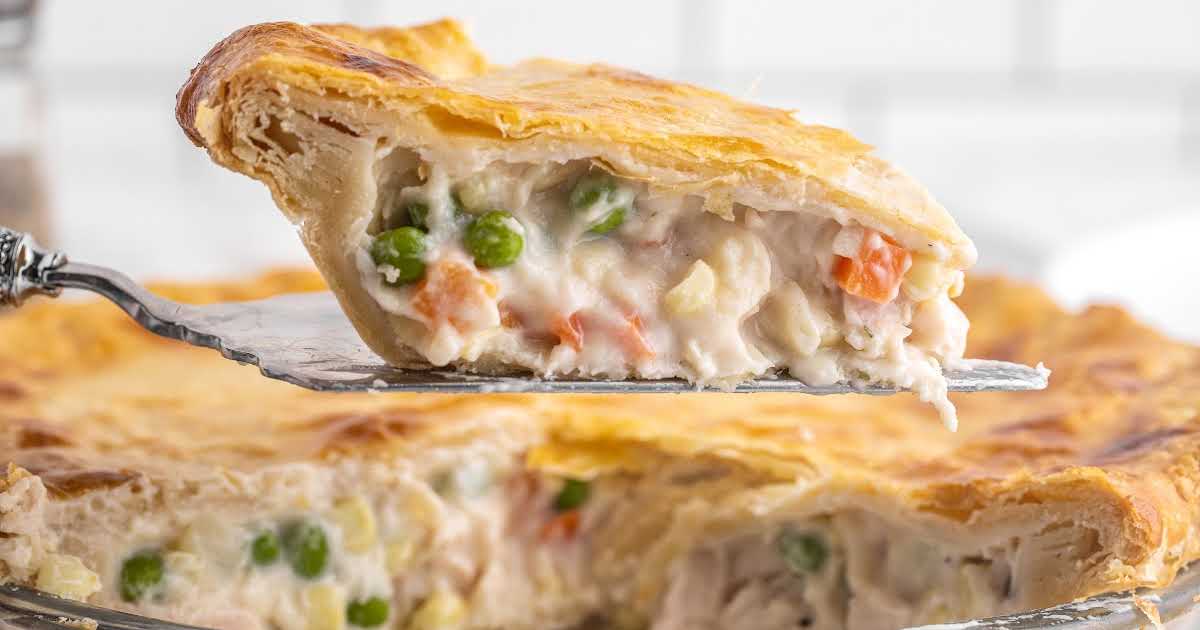 close up shot of a slice of Chicken Pot Pie on a spatula