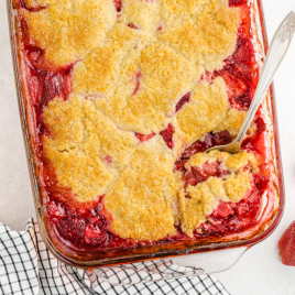 close up overhead shot of strawberry cobbler in a clear dish