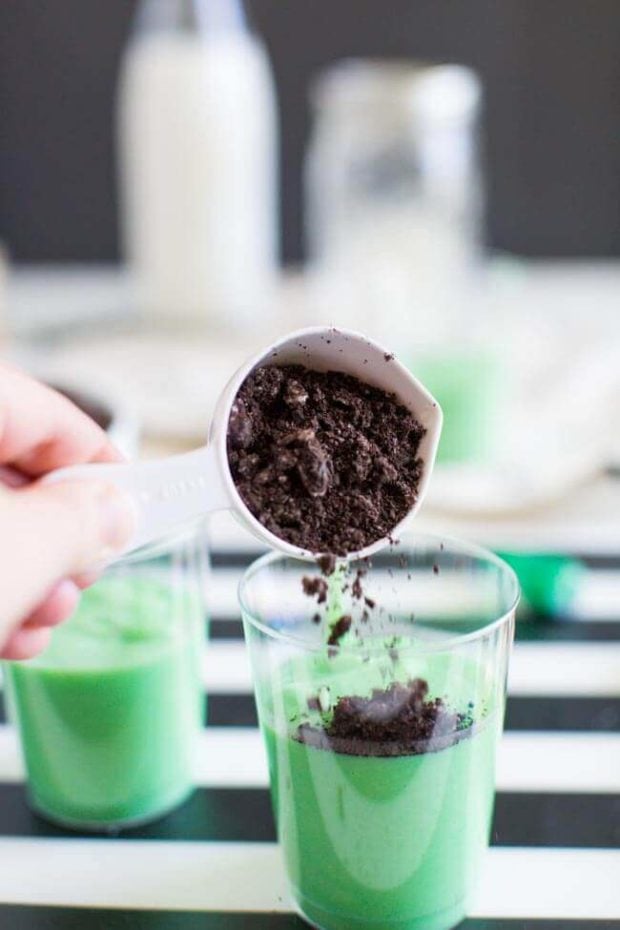 A close up of a coffee cup sitting on a table, with Pudding and Party