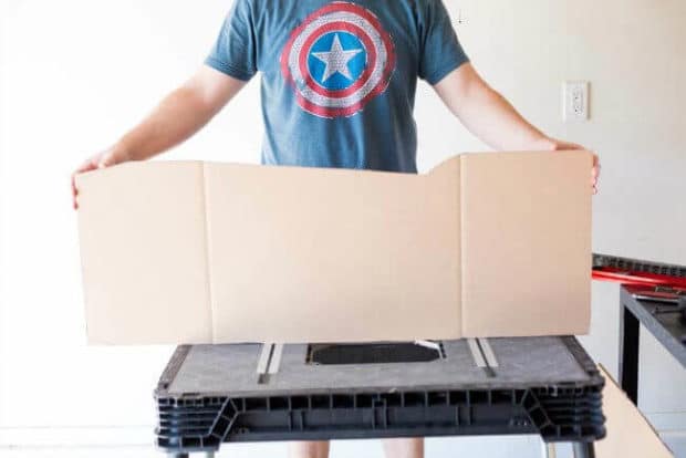 A person standing in front of a box