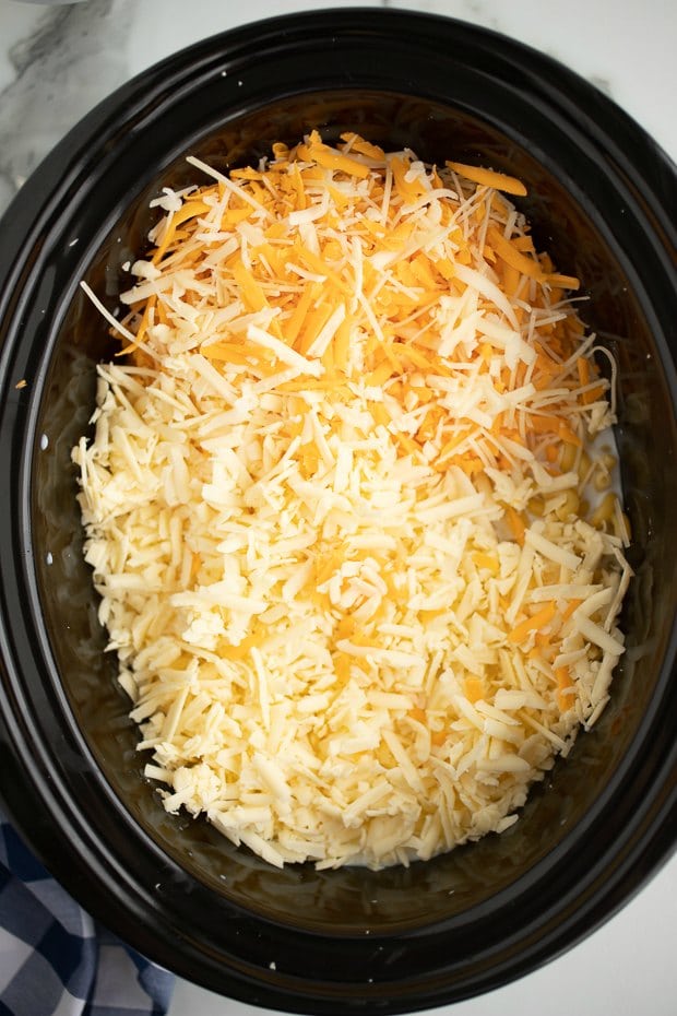 A bowl of rice on a plate, with Cheese and Cream
