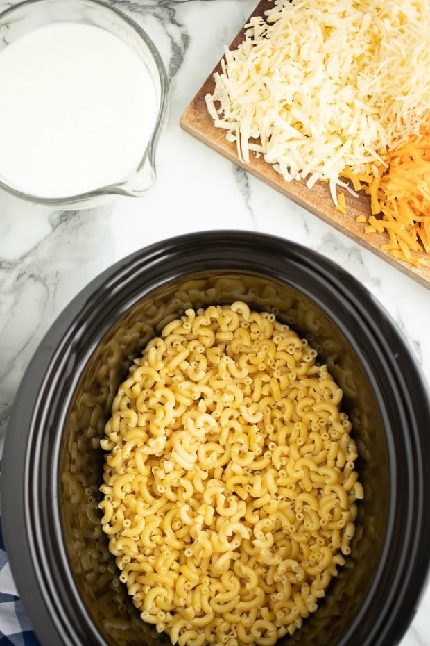 A bowl of rice on a plate, with Cheese and Slow cooker