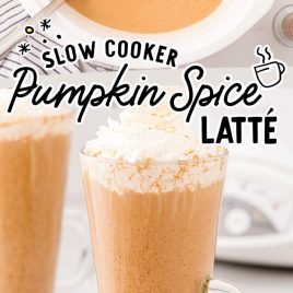two tall glasses filled with pumpkin spice latter and topped with whipped cream