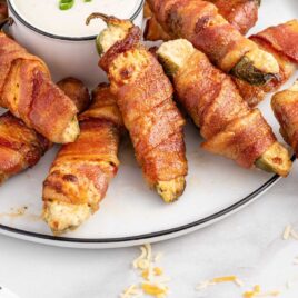 close up shot of Bacon-Wrapped Jalapeño Poppers on a plate