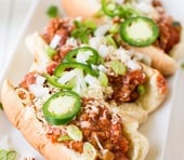 A close up of a plate of food, with Chili dog
