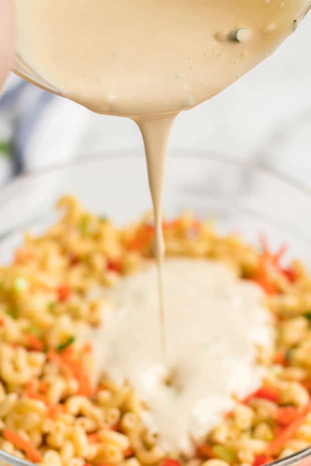 Cream Sauce Being Poured into Macaroni Pasta Salad