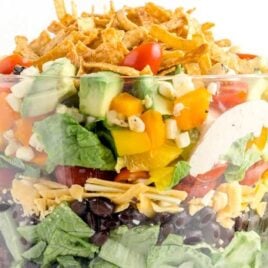 close up shot of a big serving bowl full of Mexican Layered Salad