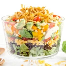 close up shot of a big serving bowl full of Mexican Layered Salad
