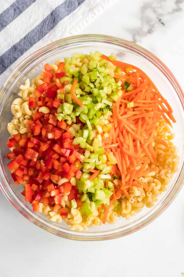 A plate of food with rice and vegetables, with Salad and Macaroni