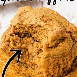 close up shot of 2-ingredient Pumpkin Spice Muffins with the muffin wrapped pealed and a bite taken out of it