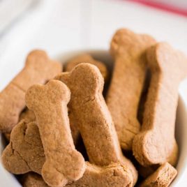 close up shot of homemade dog treats piled in a white bowl