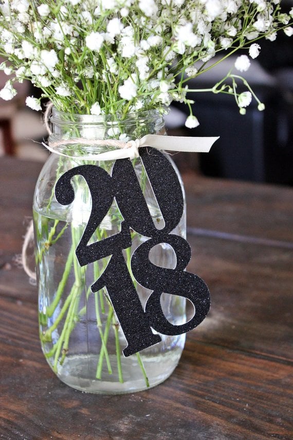 A close up of a glass vase on a table, with Party and decoration