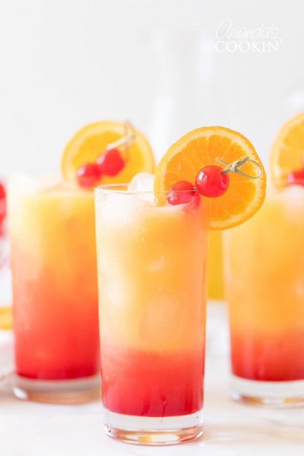 A glass of orange juice, with Tequila sunrise