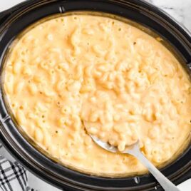 close up shot of Crockpot Mac and Cheese in a crockpot with a spoon