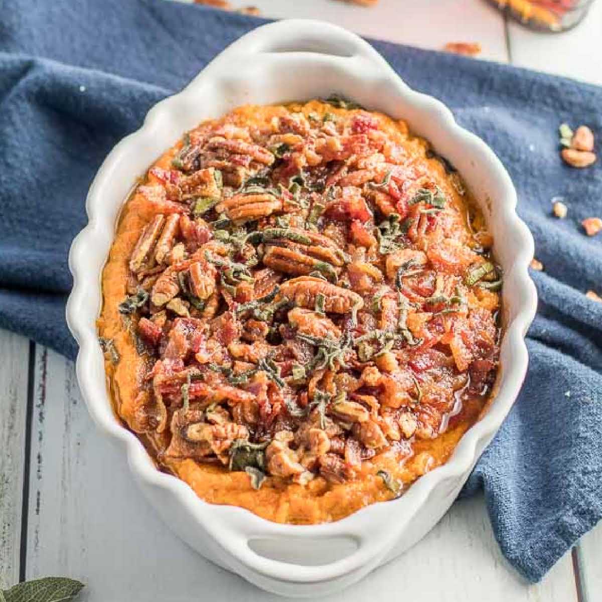 a close up shot of Sweet Potato Casserole with Pecans in a bowl