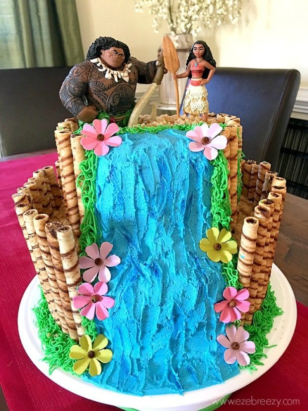 A person sitting at a table with a birthday cake