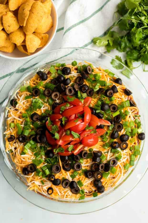 overhead shot of seven layer dip on a glass plate