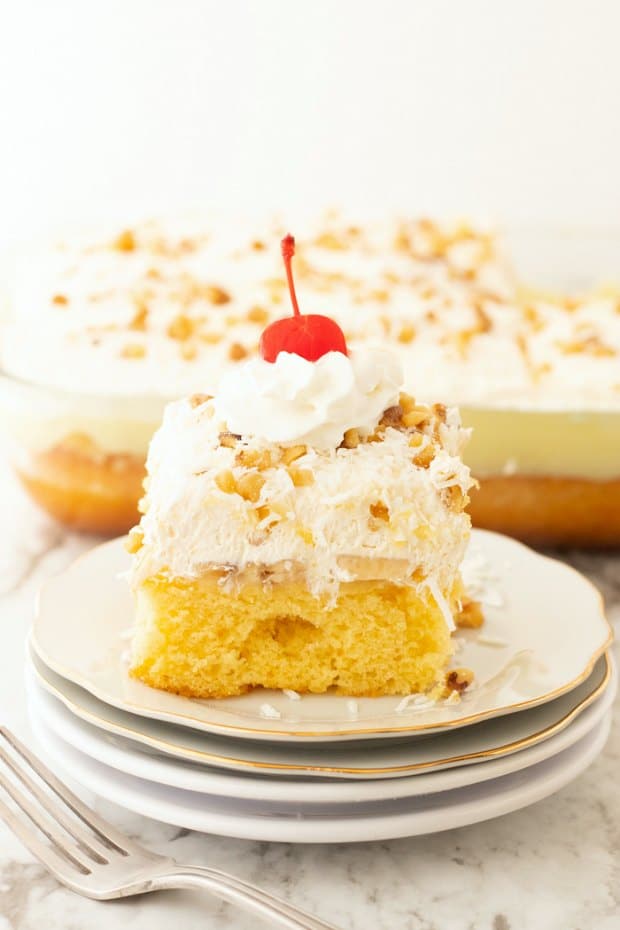 A piece of cake on a plate, with Fruit and Cupcake