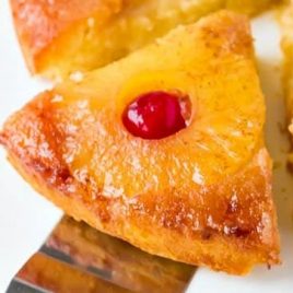 A close up of a piece of food, with Cake and Pineapple