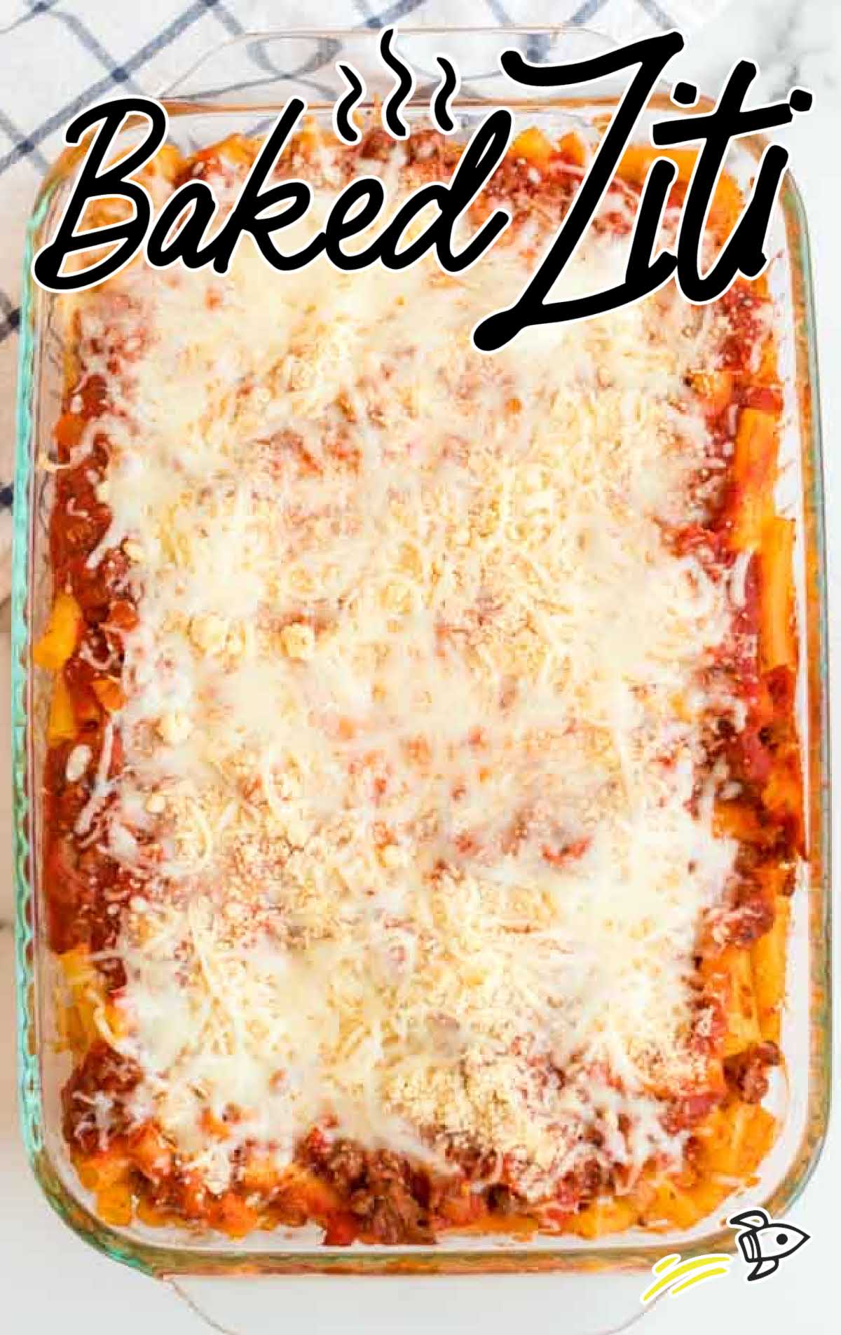 overhead shot of a baking dish of baked ziti topped with cheese
