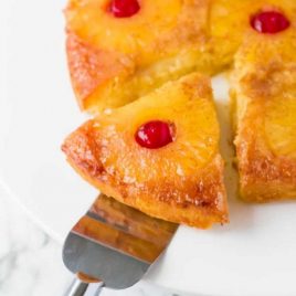 Pineapple Upside Down Cake with a slice being taken out of it