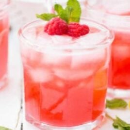 glasses of Raspberry Lemonade topped with raspberries and mint