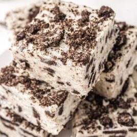 close up shot of oreo fudge stacked on top of each other on a plate