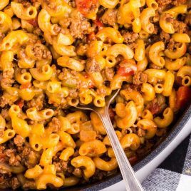 close up overhead shot of Chili Mac in a skillet with a large spoon