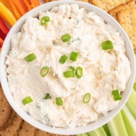 a bowl of Crab Dip topped with chopped green onions