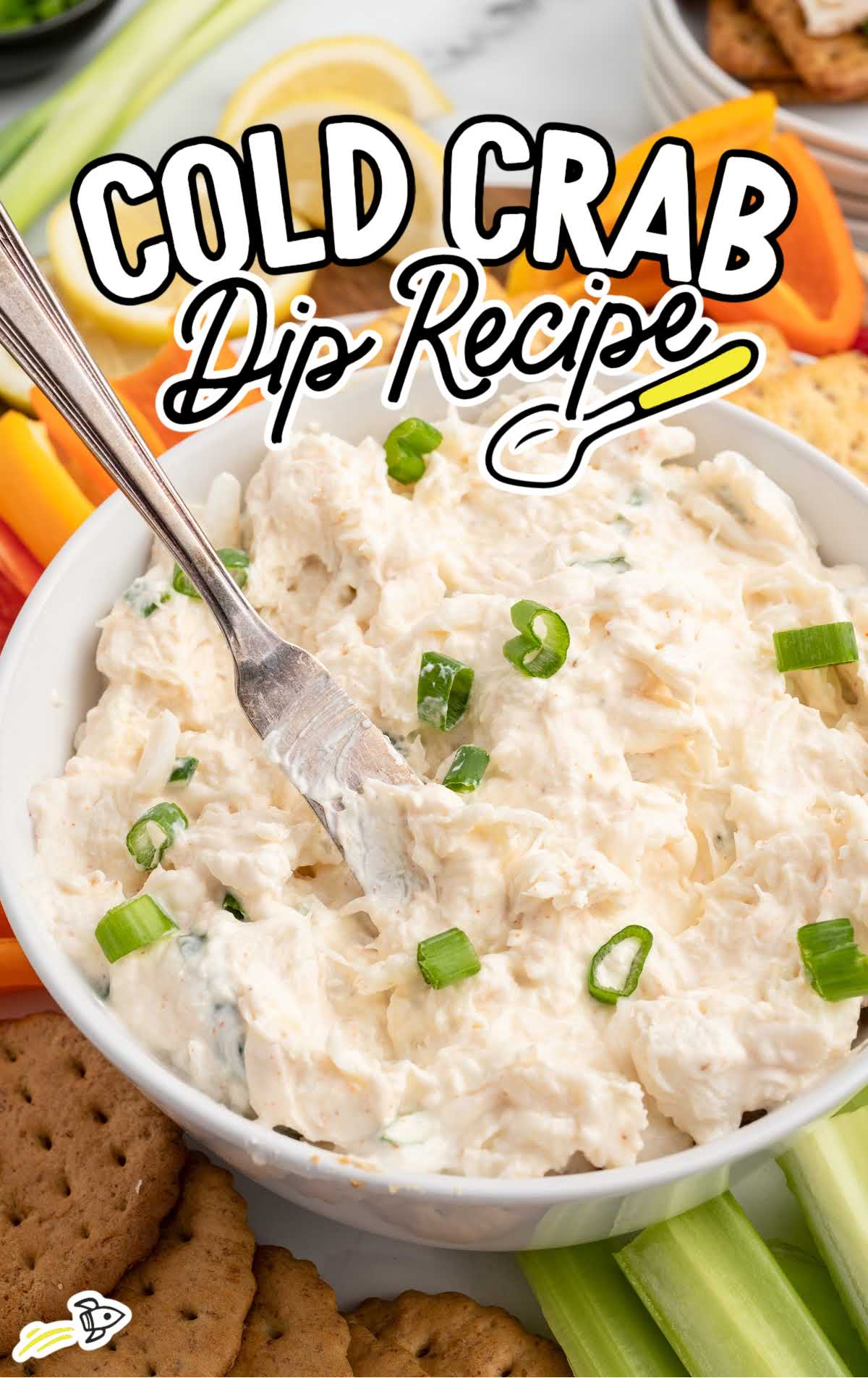 a bowl of Crab Dip topped with chopped green onions