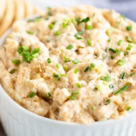 close up shot of a bowl of Hot Crab Dip garnished with chives