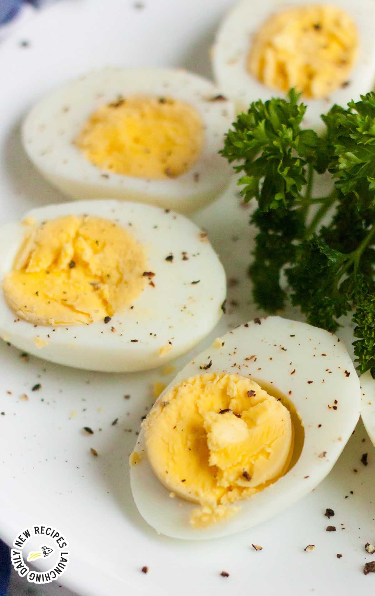 close up shot of a plate of hard boiled eggs cut in half and seasoned