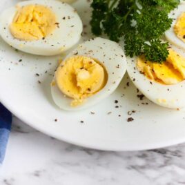 close up shot of a plate of hard boiled eggs cut in half and seasoned