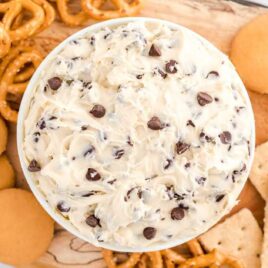 close up overhead shot of a bowl of Cookie Dough Dip served around pretzels, vanilla wafers, and crackers