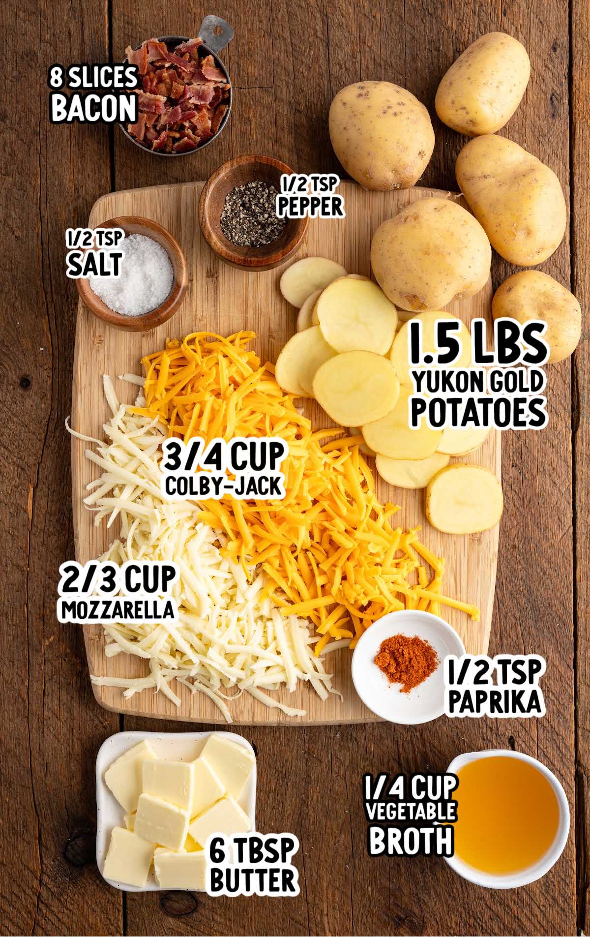 Labeled ingredients for bacon cheddar campfire potatoes including sliced Yukon gold potatoes, shredded cheeses, butter, bacon, and seasonings.